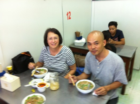 Jan and Tan enjoying banh da noodle fish soup (my photo).