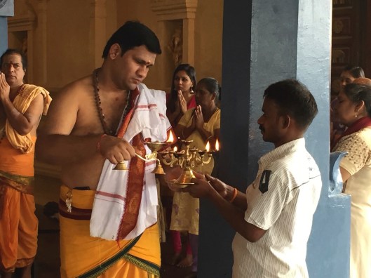 A HIndu blessing at the Batu Caves (notice the iPhone in the priest's robe).