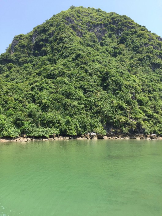 The green water of noon surrounds. Cat Ba Island.